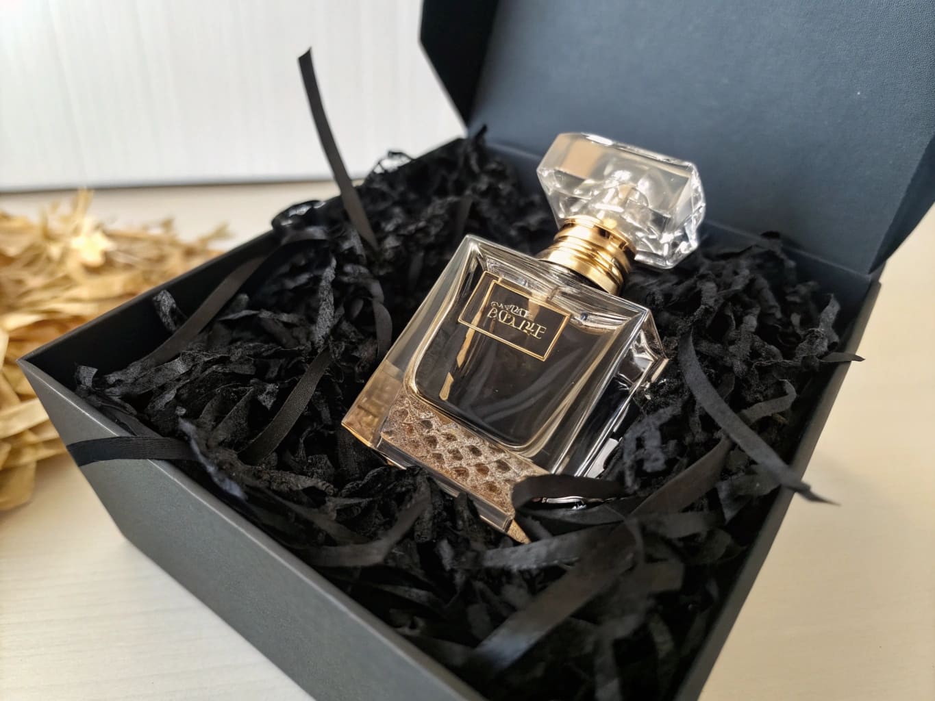 Luxury perfume in dramatic black shred presentation