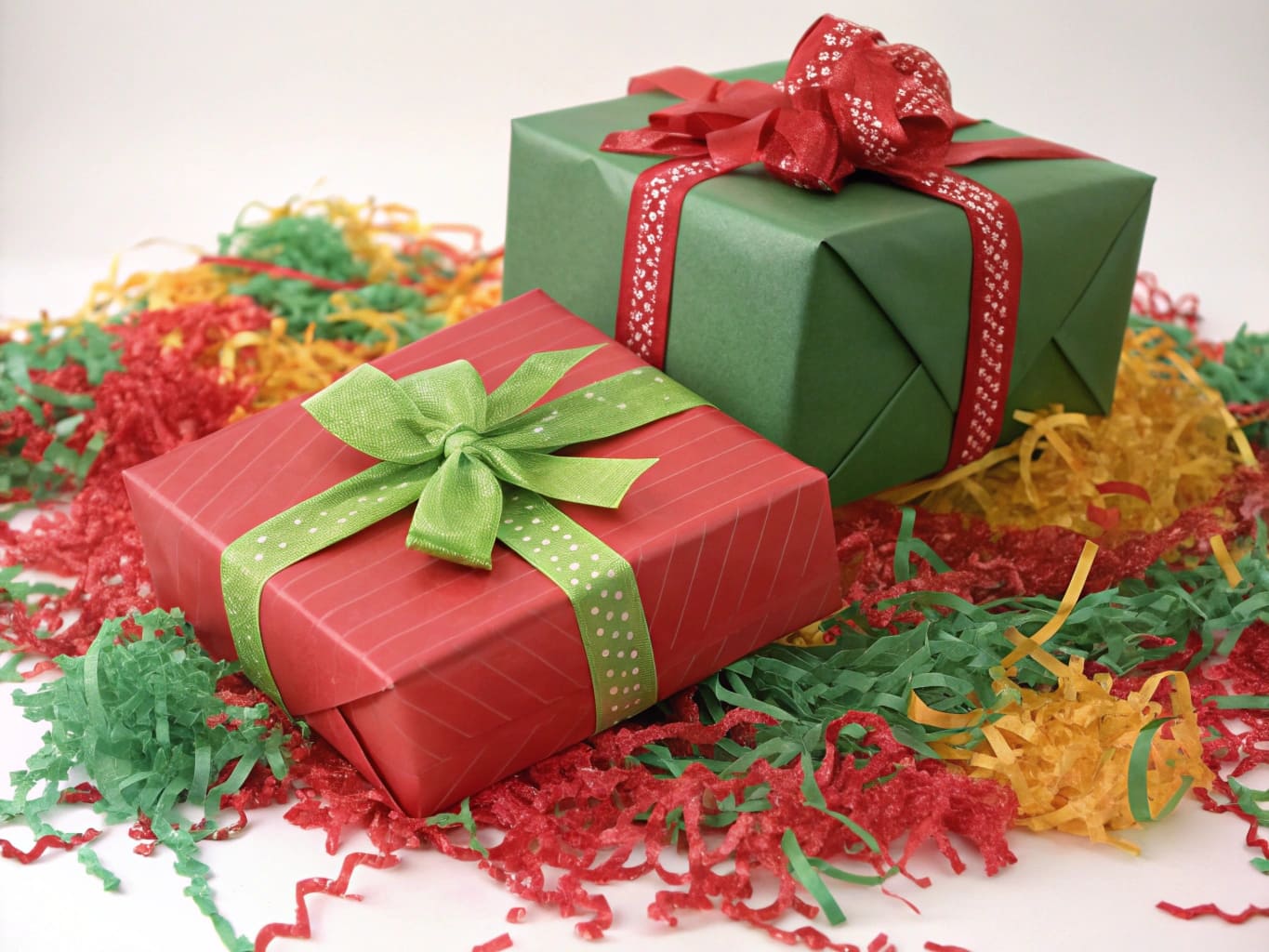 Seasonal holiday packaging with festive colored shred